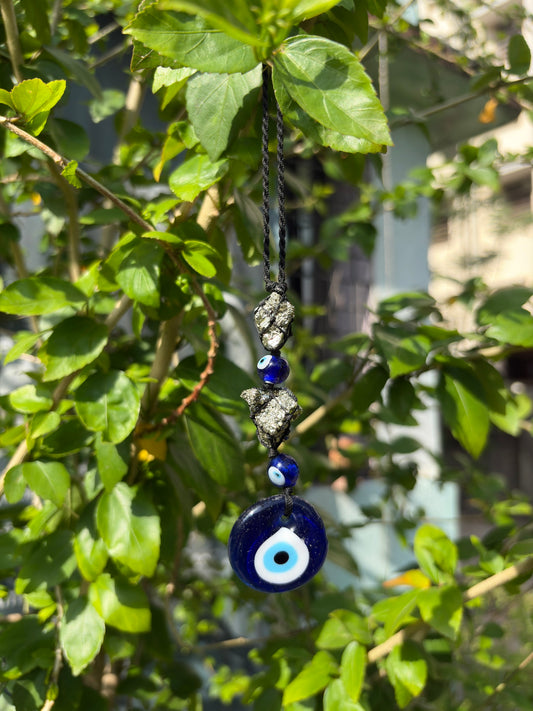 Pyrite evil eye hanger hanging on wall for home protection and decor