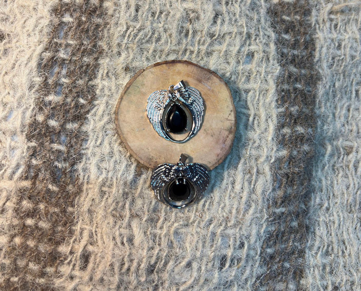 Black Obsidian crystal angel pendant symbolizing protection, transformation, and resilience