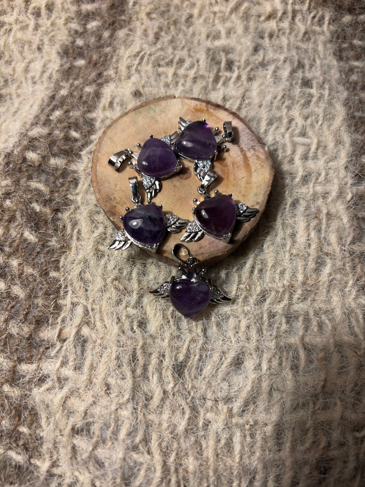 Amethyst crystal winged heart necklace symbolizing intuition and spiritual growth