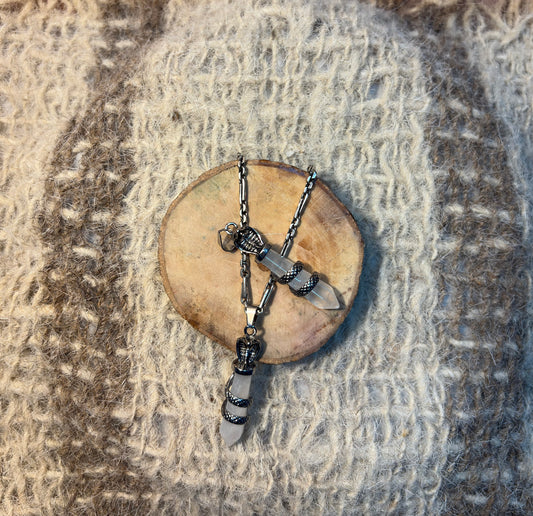 Clear Quartz crystal snake necklace symbolizing transformation, wisdom, and spiritual awareness