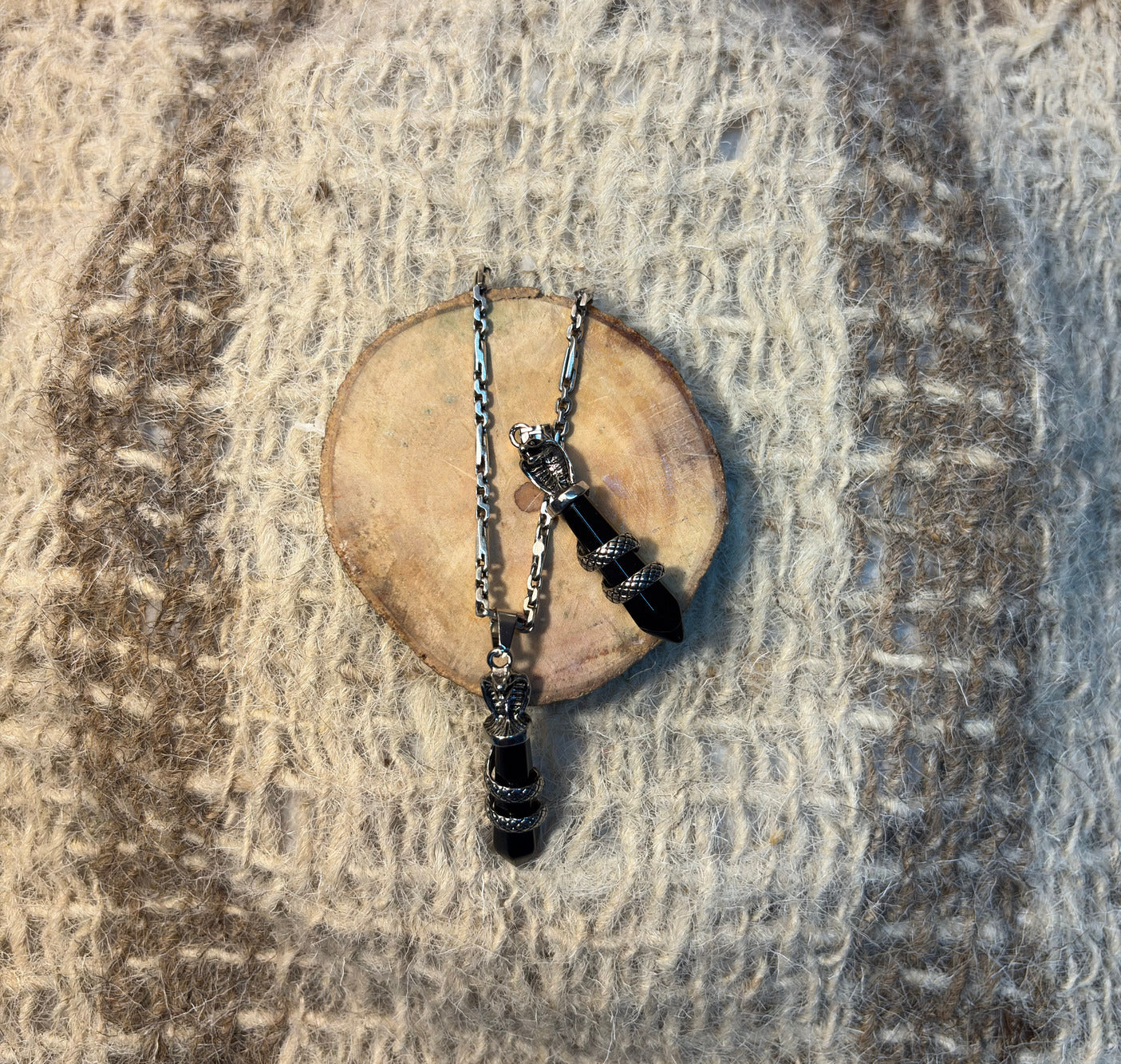 Black Obsidian crystal snake necklace symbolizing protection, wisdom, and rebirth