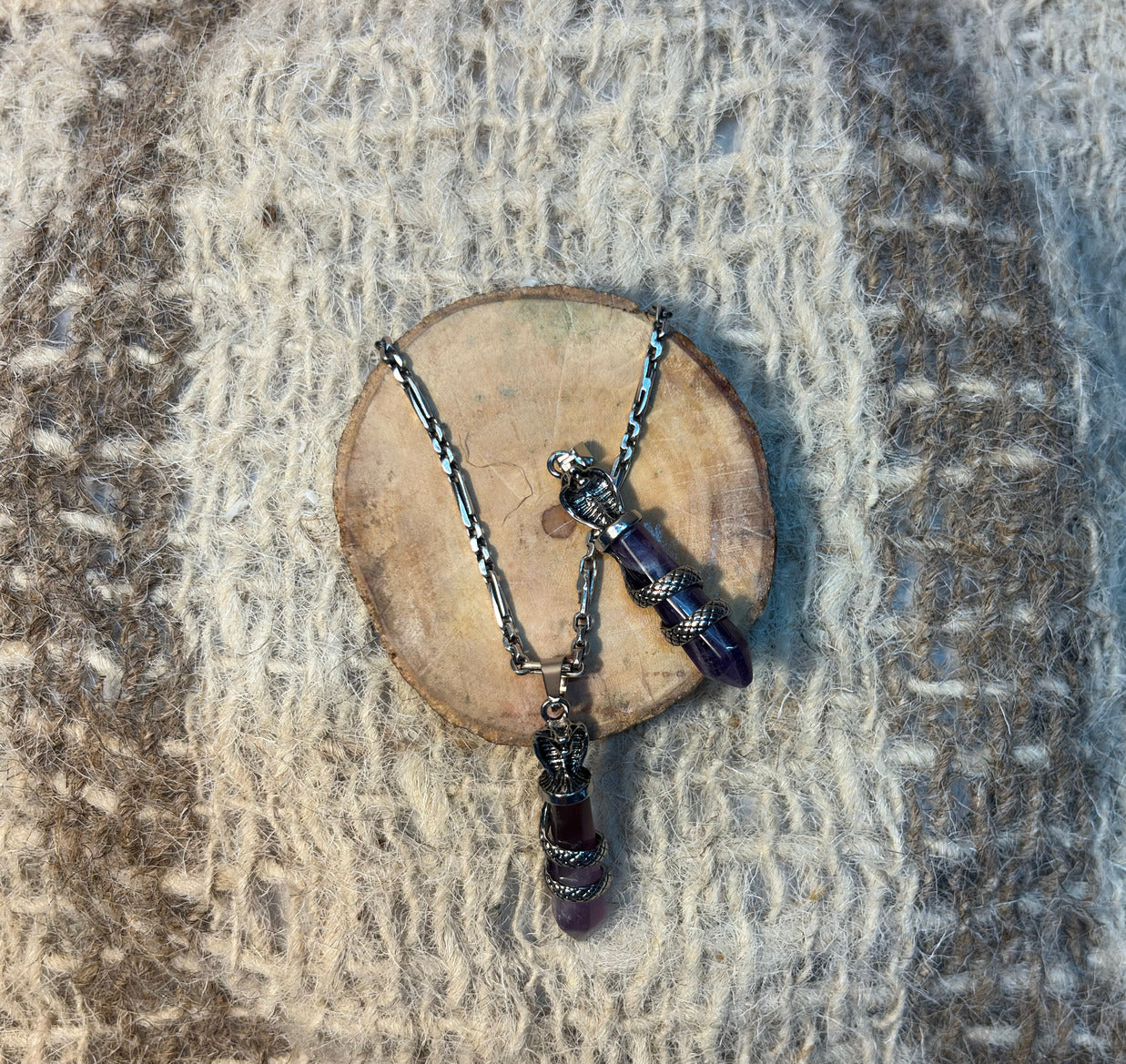 Amethyst crystal snake necklace symbolizing wisdom, transformation, and spiritual awakening